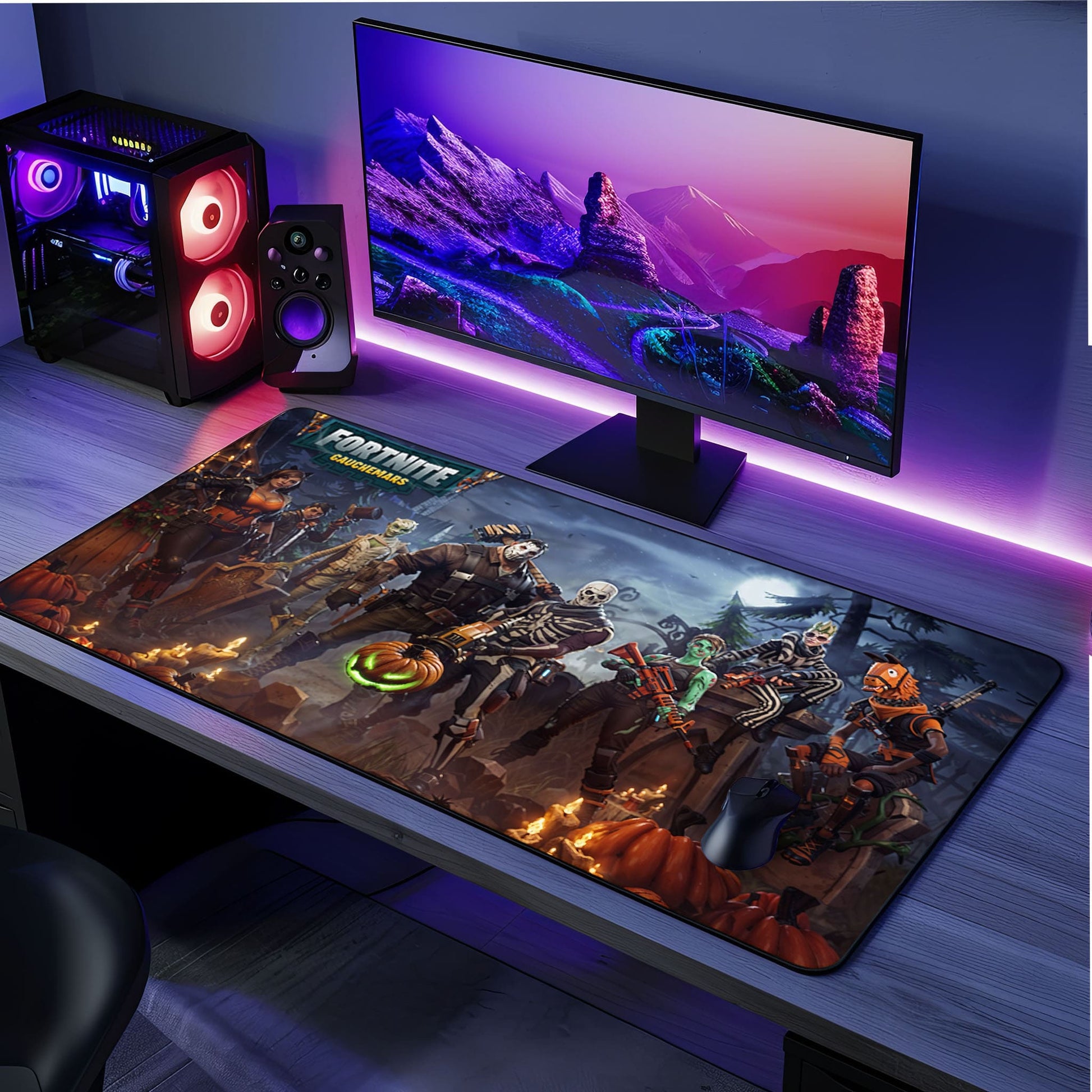 Une configuration gaming élégante avec un grand écran affichant un paysage montagneux, un PC avec des lumières LED colorées, des haut-parleurs et un tapis de souris Fortnite représentant des personnages d'Halloween sur un bureau gris. Parfait pour les fans de Fortnite et d'Halloween.